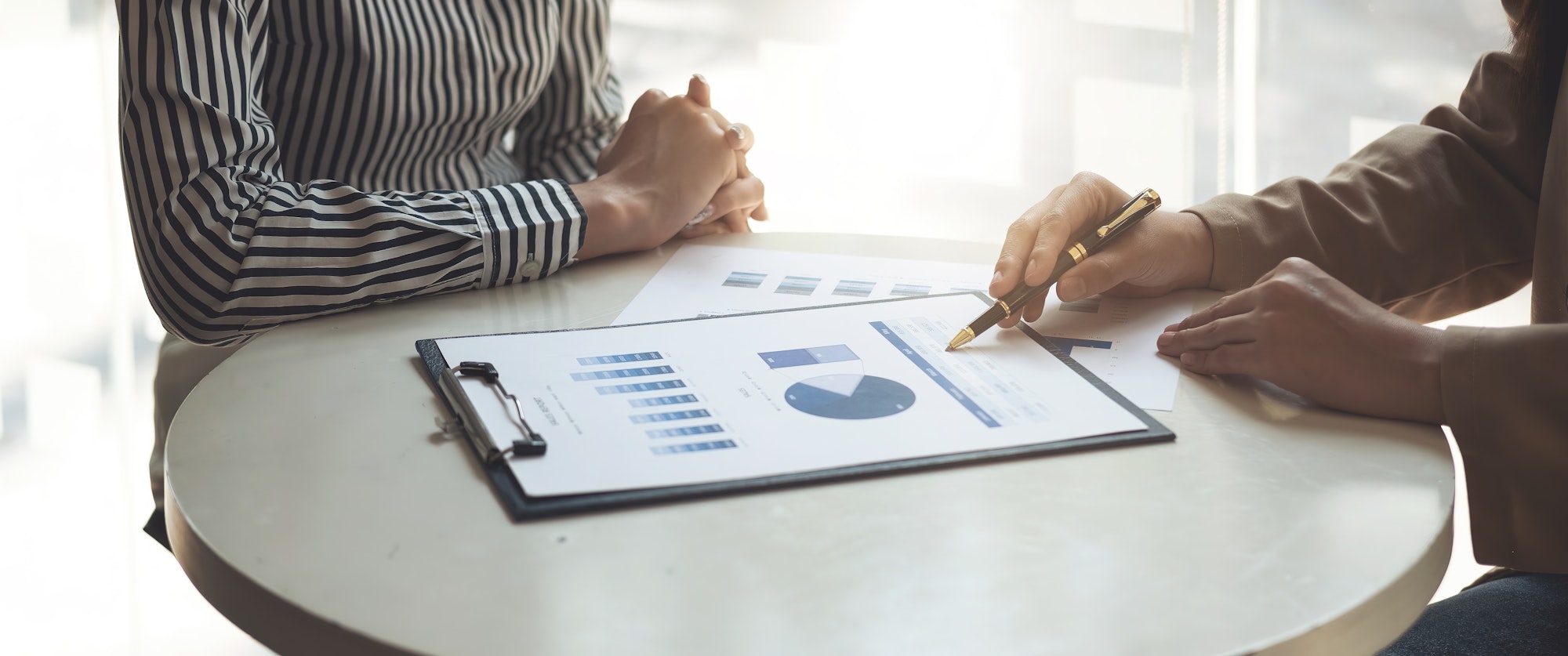 Group of Businesswoman and Accountant checking data document on paperwork chart report for investiga